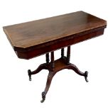 A 19th Century mahogany fold-over tea table with canted corners and rosewood banding to the top,