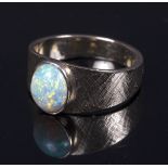 An opal ring to a textured 14k gold shank Condition Report: The Opal has some