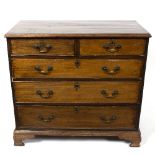 An early 19th Century mahogany chest of two short over three long drawers raised on ogee bracket