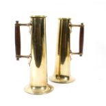 A pair of brass measures of tall tapered form with flared base and turned wooden handle,