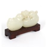 A Chinese jade carving of two mandarin ducks and a lotus flower, on a hardwood stand,