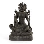An Indian bronze figure of a seated immortal on a grotesque beast, 35.