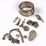 A Victorian silver buckle bangle, an engraved foliate brooch mounted a glass cylinder verso,