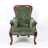 A Victorian armchair with moulded walnut frame, deep button upholstery,