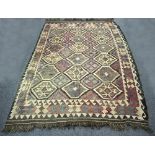 A Kilim rug worked in browns, cream and blue,