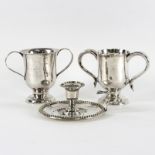 Two Old Sheffield plate two-handled cups, 13cm high and a chamberstick, 15.