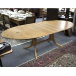 An elm extending dining table fitted an extra leaf on splay feet,