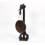 A bronze and wrought iron gong on stand, surmounted by an elephant mask and on scroll feet,
