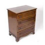 An Edwardian mahogany chest of four drawers, crossbanded in satinwood, on splay feet,