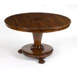 An early Victorian rosewood breakfast table on tapering column to a circular platform on three paw