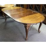 An early 20th Century extending dining table, the top with D ends and two extra leaves,