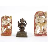 A small Indian bronze figure of Ganesh on a square plinth, the eyes and stomach set with red stones,