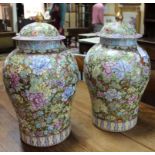 A large pair of Chinese Famille Rose Millefleur vases and covers, to a gilt ground,