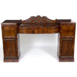 A late Regency mahogany pedestal sideboard, the backboard with scrolls and acanthus carving,