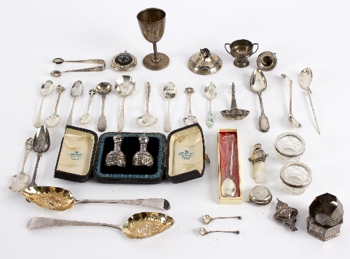 A large quantity of silver comprising souvenir teaspoons, a compact with tortoiseshell cover,