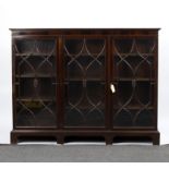 An Edwardian mahogany bookcase, fitted adjustable shelves enclosed by glazed doors, on square feet,