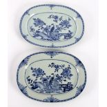 Two Chinese export blue and white oval plates decorated a phoenix beneath flowering chrysanthemums,