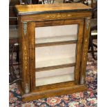 A Victorian inlaid walnut cabinet enclosed by a glazed door,