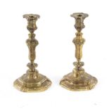 A pair of ormolu candlesticks of Louis XVI style, with rococo type decoration, 27.