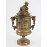 An Italian gilt metal two-handled cup and cover, with putto finial and band of bacchanalian putti,