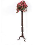 A mahogany torchère, with spiral column on a tripod base, 145cm high,