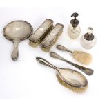 A silver backed dressing table set, H M, Birmingham 1911, comprising hand mirror,