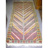A Gendje rug with central zig-zag field field within a geometric border,