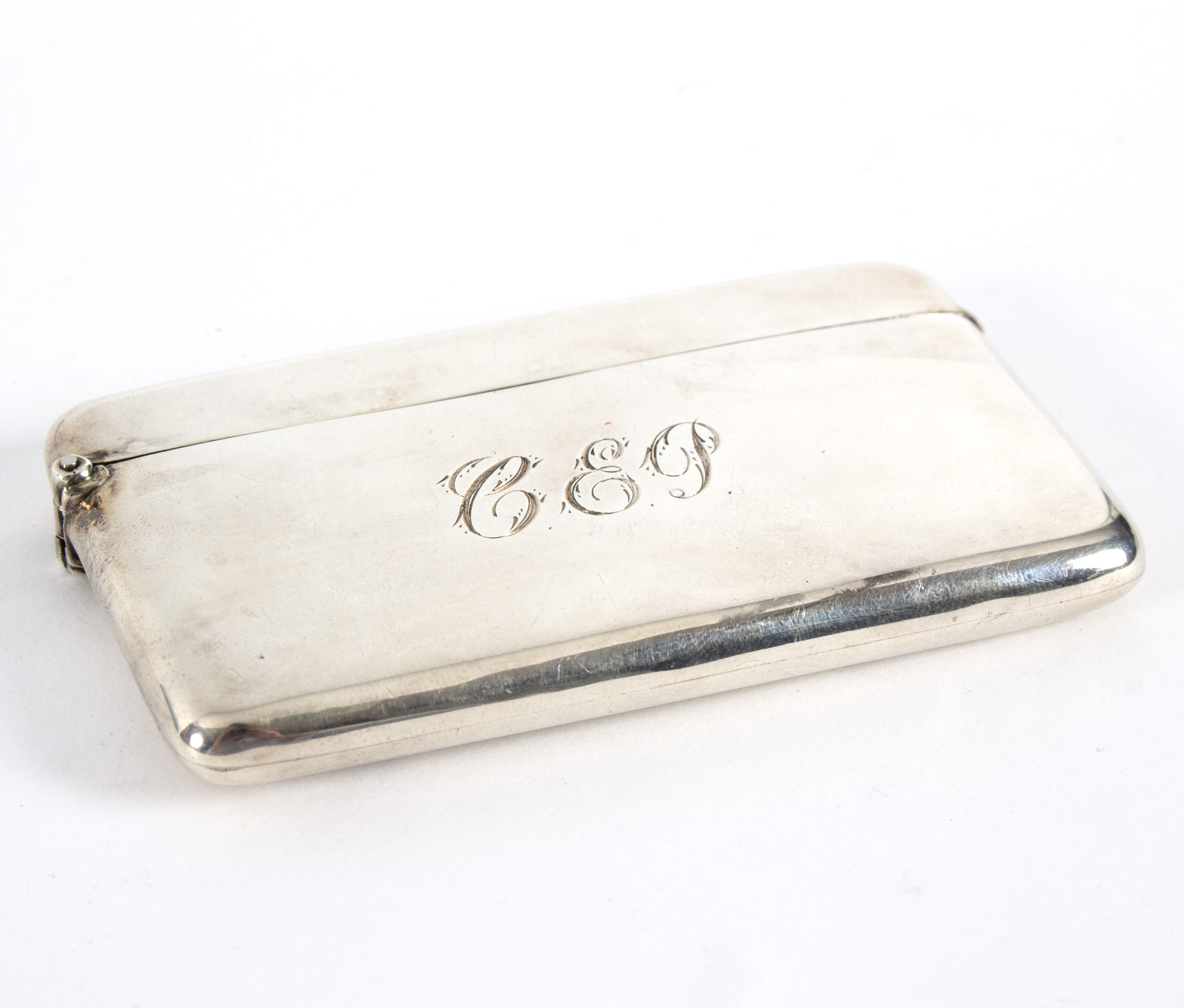 A silver visiting card case, A & J Zimmerman Ltd, Birmingham 1899, of plain rectangular form, 8.