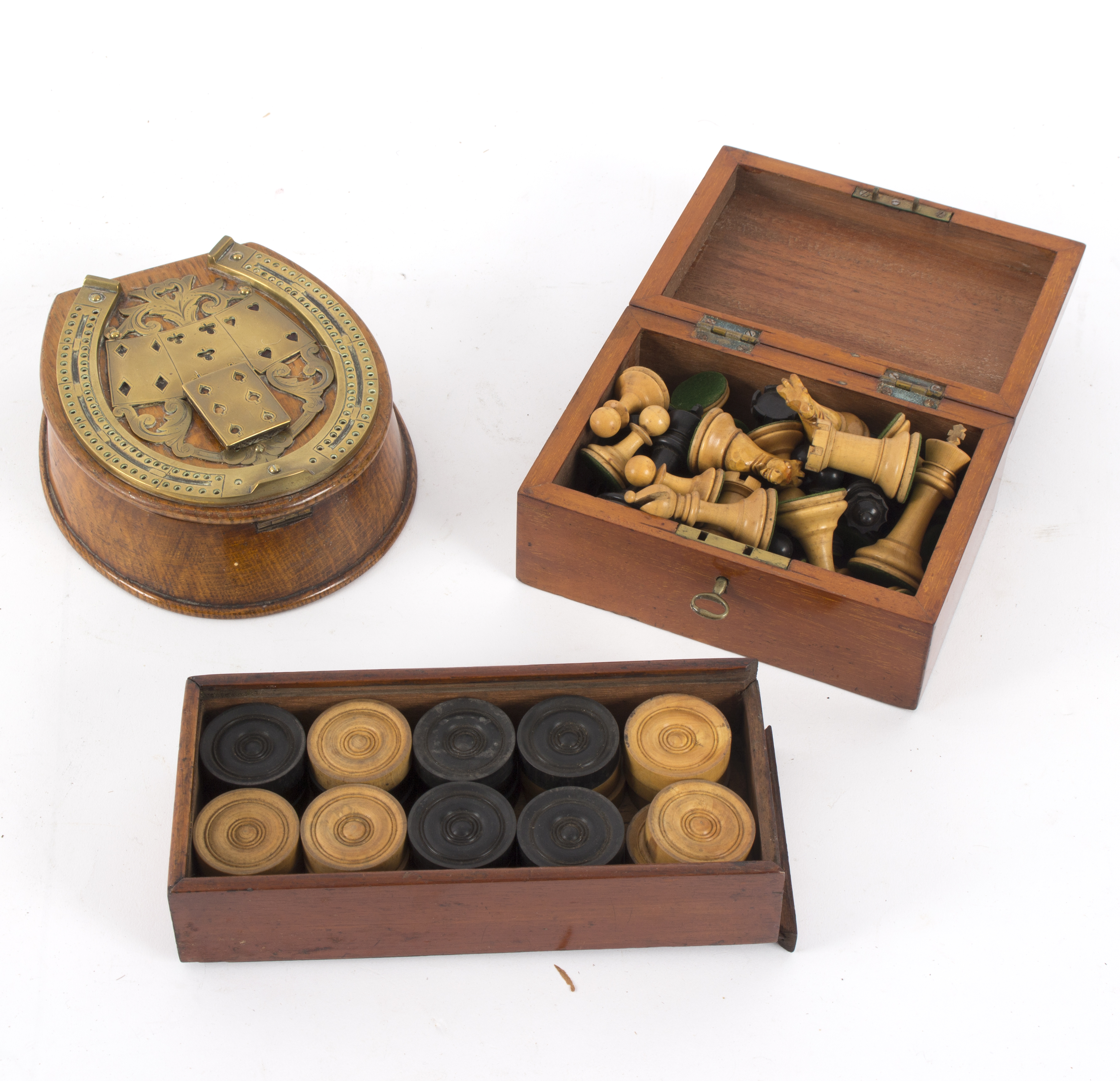 A brass horseshoe cribbage marker, mounted to an oak box,