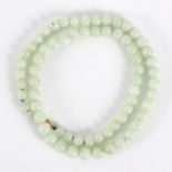 A single row of celadon jade beads, 48.