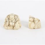 A carved ivory netsuke, 19th Century, depicting a seated figure holding a fan, 4.