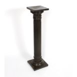 A simulated bronze column torchère with square top and garlands of flowers to the capital,