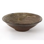 A Japanese Karatsu bowl, with trailed decoration in green, red and yellow,