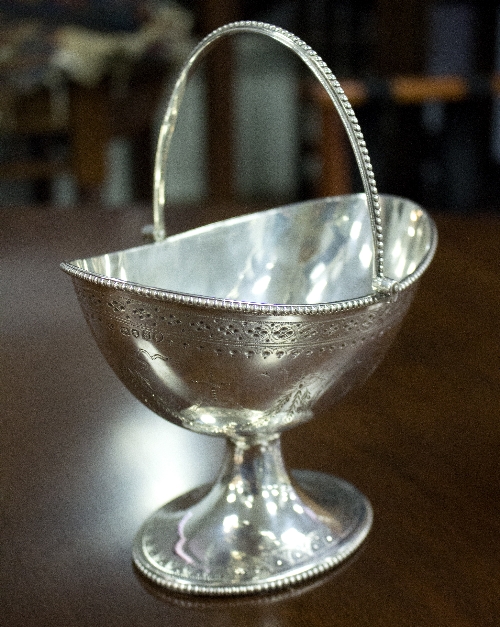 A Georgian silver swing-handled pedestal bowl, Henry John Lias, London 1873,