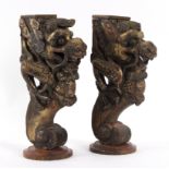 A pair of Chinese painted and decorated dragon supports, with scroll bases,