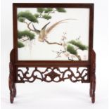 A Chinese silk embroidered table screen, 20th Century, decorated a bird on a branch,