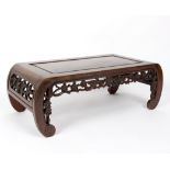 A rectangular opium table with rounded ends, carved lotus blossom to the frieze and ends,