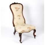 A Victorian rosewood chair with upholstered seat and padded back on moulded cabriole legs