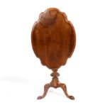 A shaped oval walnut table, the top with moulded border,