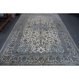 A Nain rug with floral designs on a cream ground,