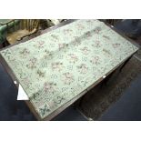 An Aubusson style rug, worked with roses within a grid to a pale green ground,