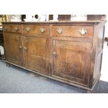 An oak dresser with shelves over, fitted drawers and cupboards beneath,