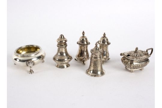 A group of silver pepperettes and salts to include a circular salt, London 1863, with beaded border,