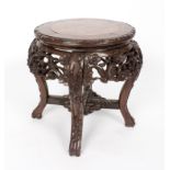 A Chinese hardwood stand with marble top, the whole carved prunus blossom,