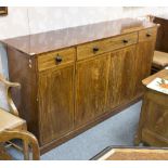 A Regency mahogany cupboard, with three frieze drawers above four panel doors, banded in boxwood,