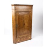 An early 19th Century oak corner cupboard with drawer and false drawer beneath,
