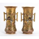A pair of Japanese satsuma two-handled vases, painted portraits of Immortals on a gilded ground,