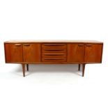 G Plan, a teak sideboard with four drawers, flanked panelled cupboard doors,