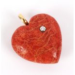 A coral heart-shaped pendant set with a diamond of approximately 0.