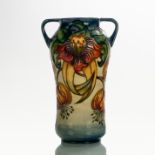 Moorcroft, an Anna Lily pattern twin-handled vase, with tubeline decoration,